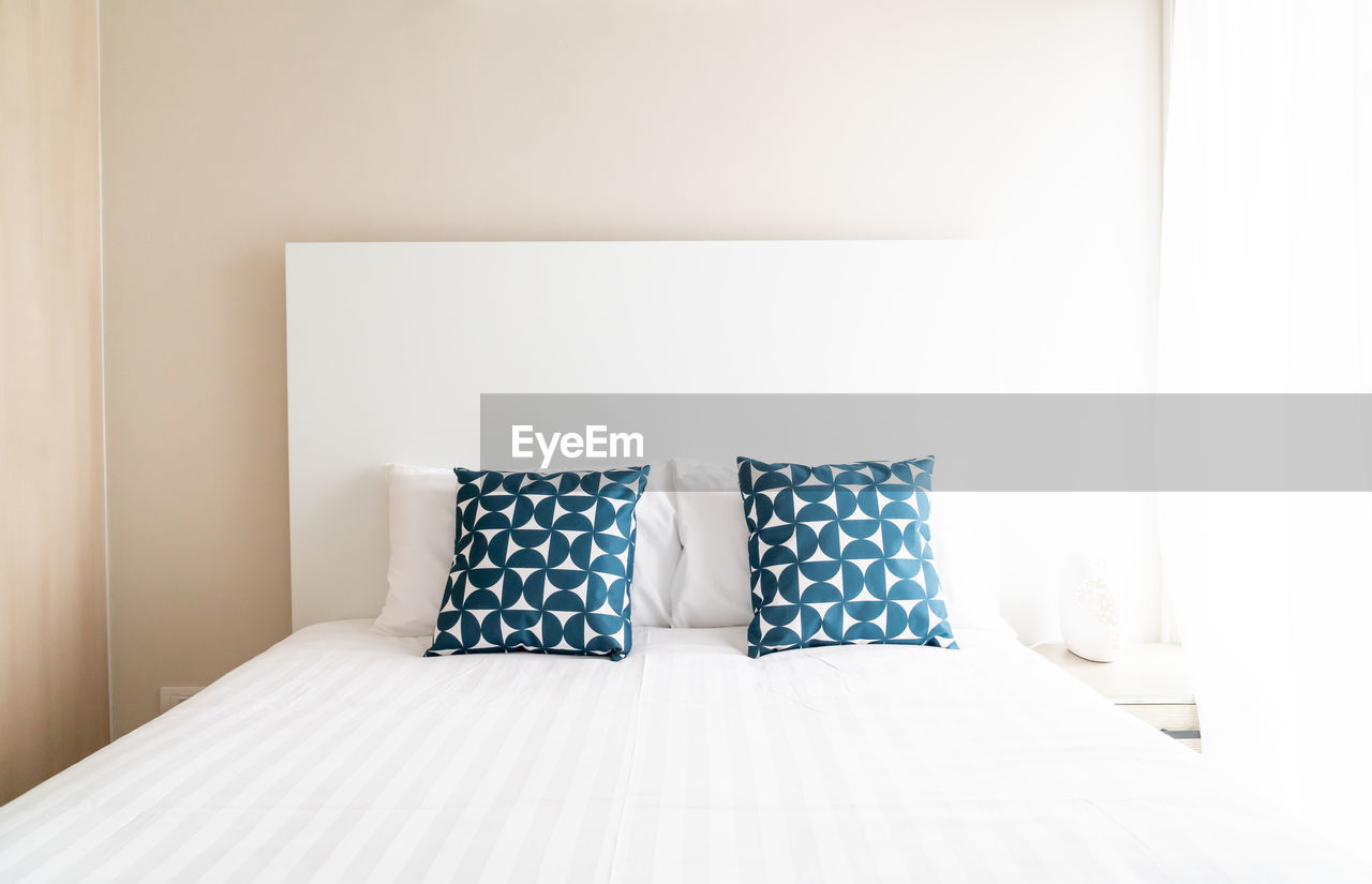 Cushions on bed at home