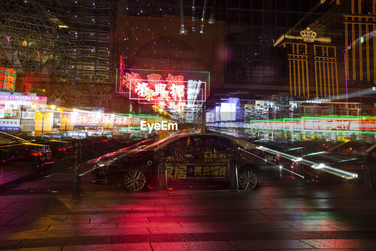 ILLUMINATED STREET AND BUILDINGS AT NIGHT