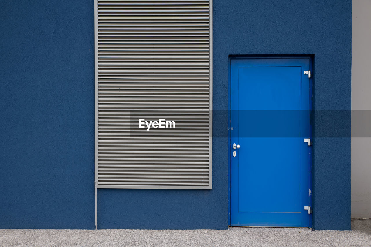 Closed blue door of building