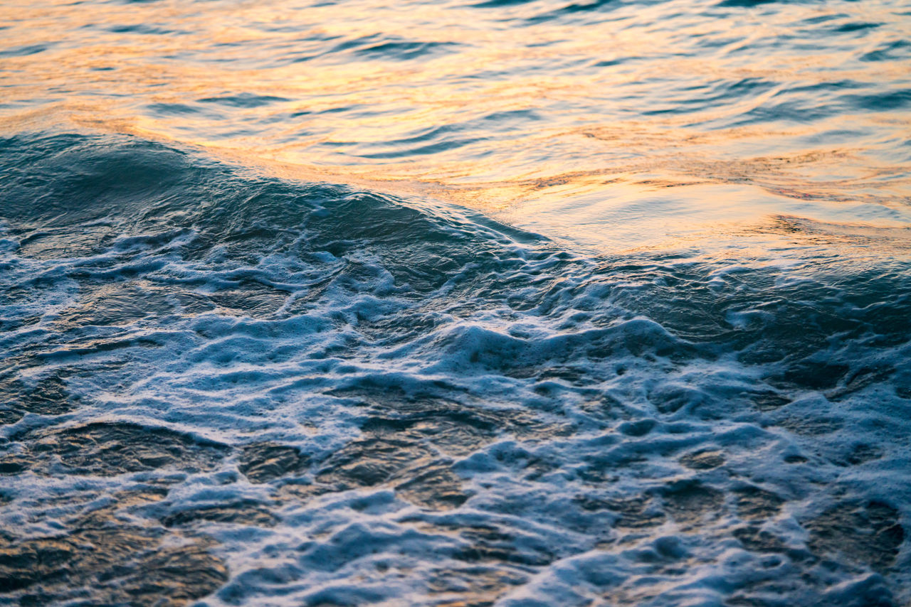 Ocean water at sunset with waves crushing