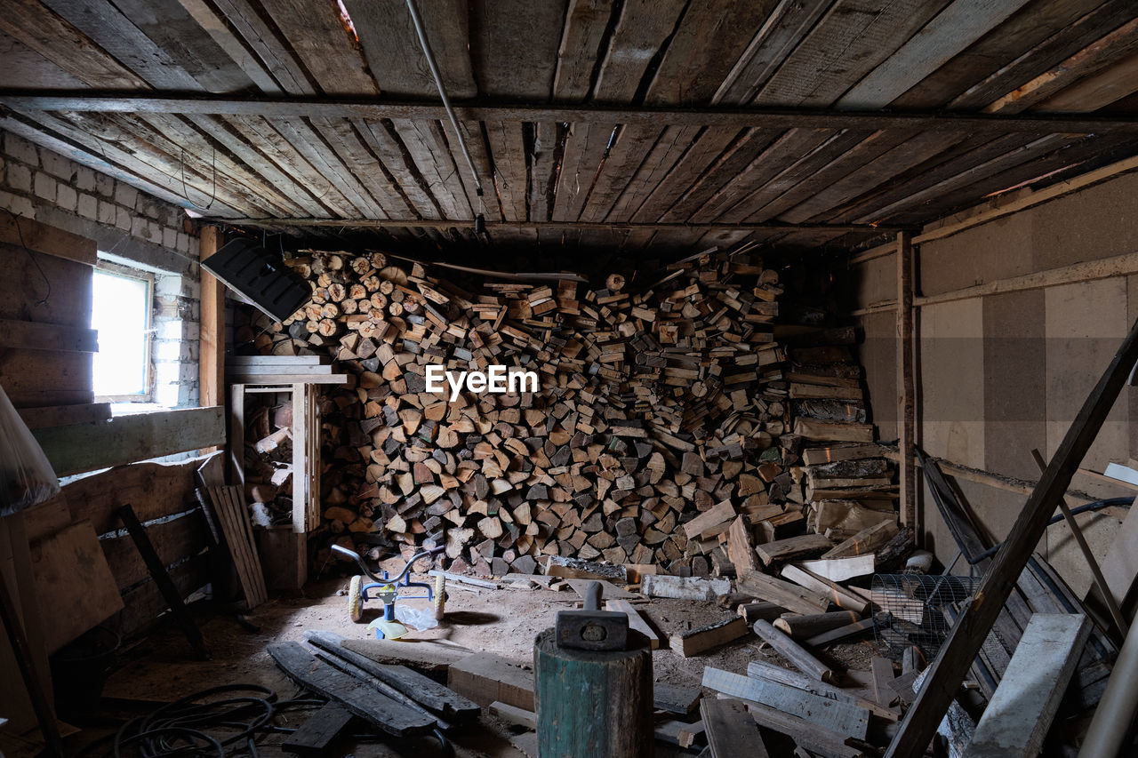 STACK OF FIREWOOD IN ROOM