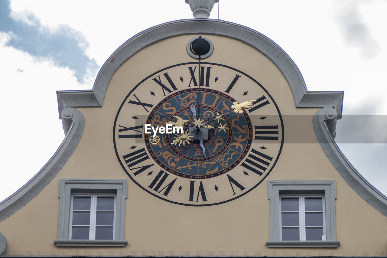 LOW ANGLE VIEW OF CLOCK AGAINST SKY