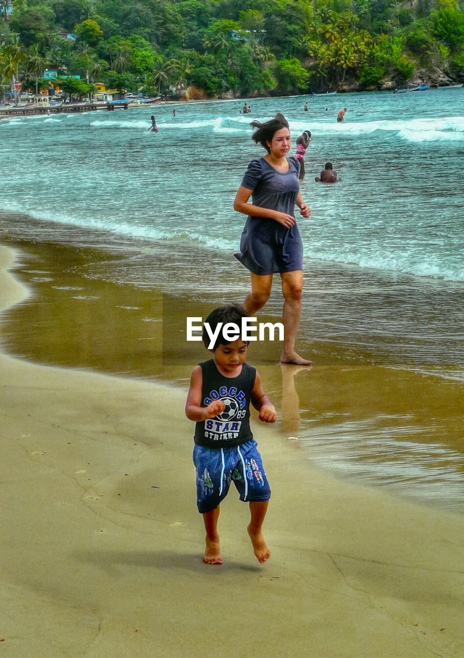 HIGH ANGLE VIEW OF HAPPY GIRL ENJOYING IN WATER