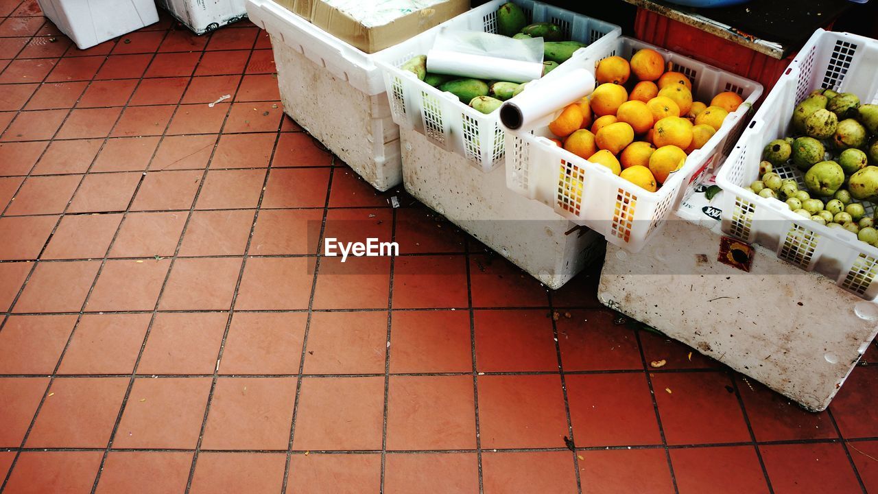 High angle view of fruits in crates at market for sale