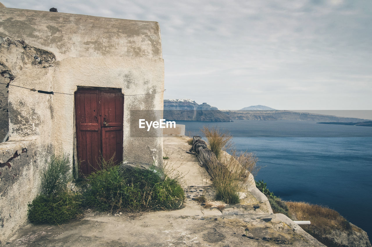 BUILT STRUCTURE BY SEA AGAINST MOUNTAIN