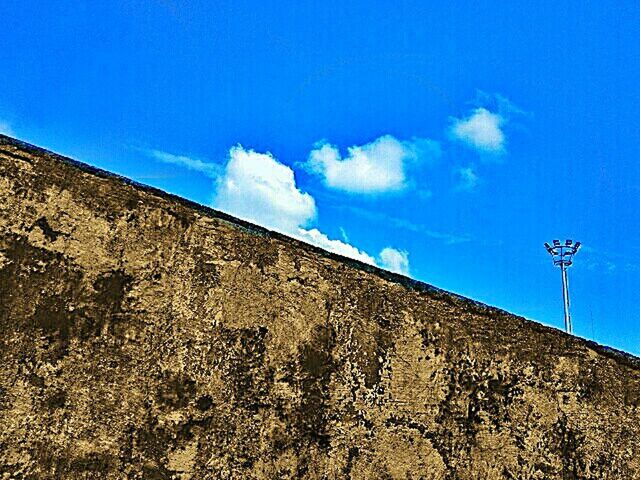 LOW ANGLE VIEW OF BUILT STRUCTURES AGAINST BLUE SKY