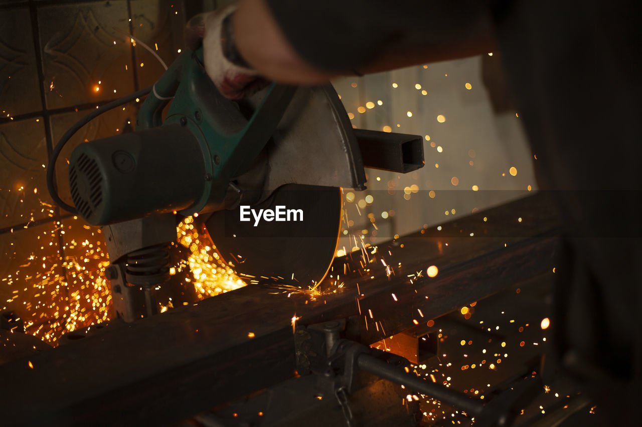 low angle view of man holding illuminated light at night