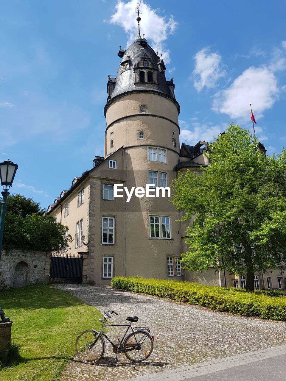 BICYCLE BY ROAD AGAINST BUILDINGS