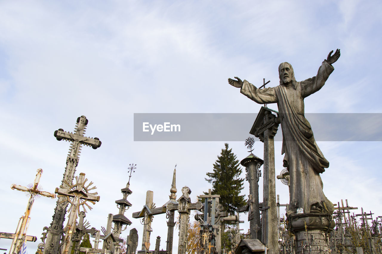 Low angle view of statue against sky, hill of croses