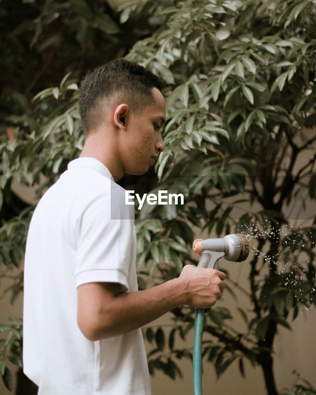 Full length of boy holding plant