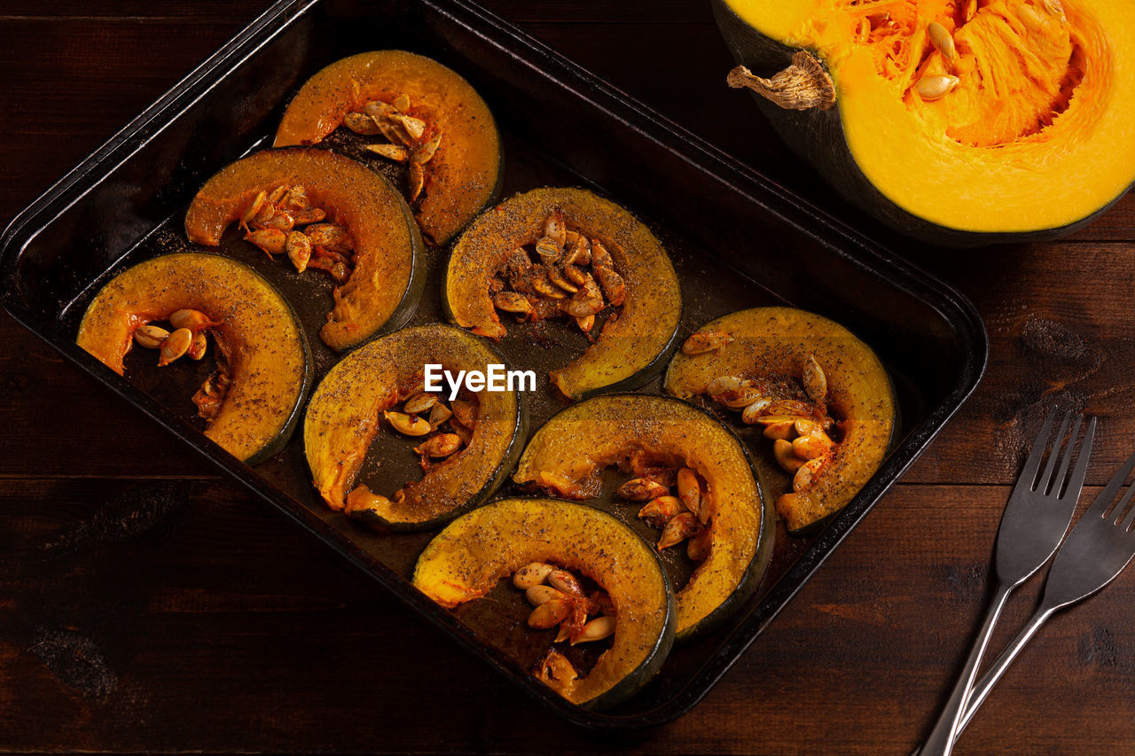 Oven-baked pumpkins on a baking sheet top vew