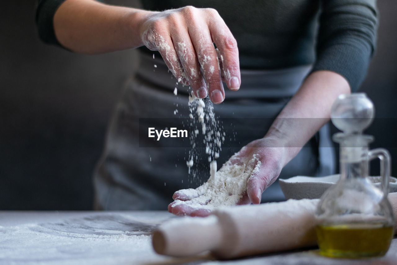 Woman baker with flour in her hands