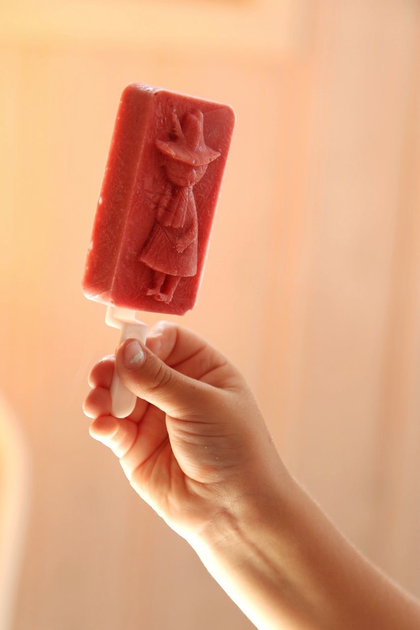 Cropped image of child holding ice cream