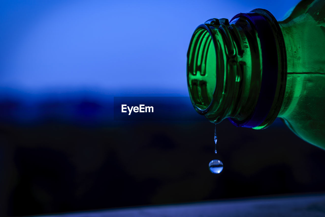 Close-up of water dripping from bottle