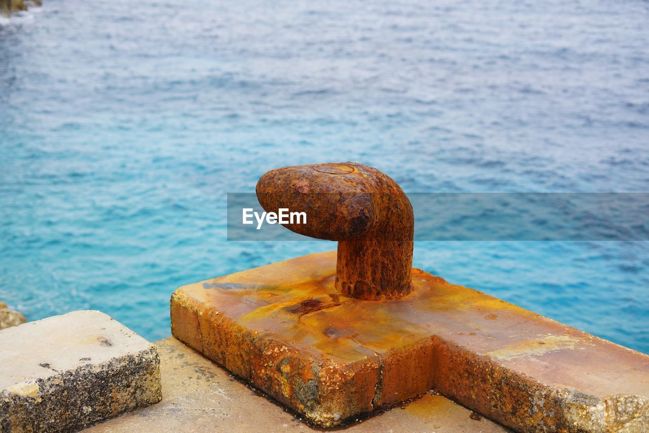 water, sea, rock, rusty, no people, wood, sand, nature, day, metal, ocean, shore, outdoors, focus on foreground, coast, close-up, beauty in nature, tranquility