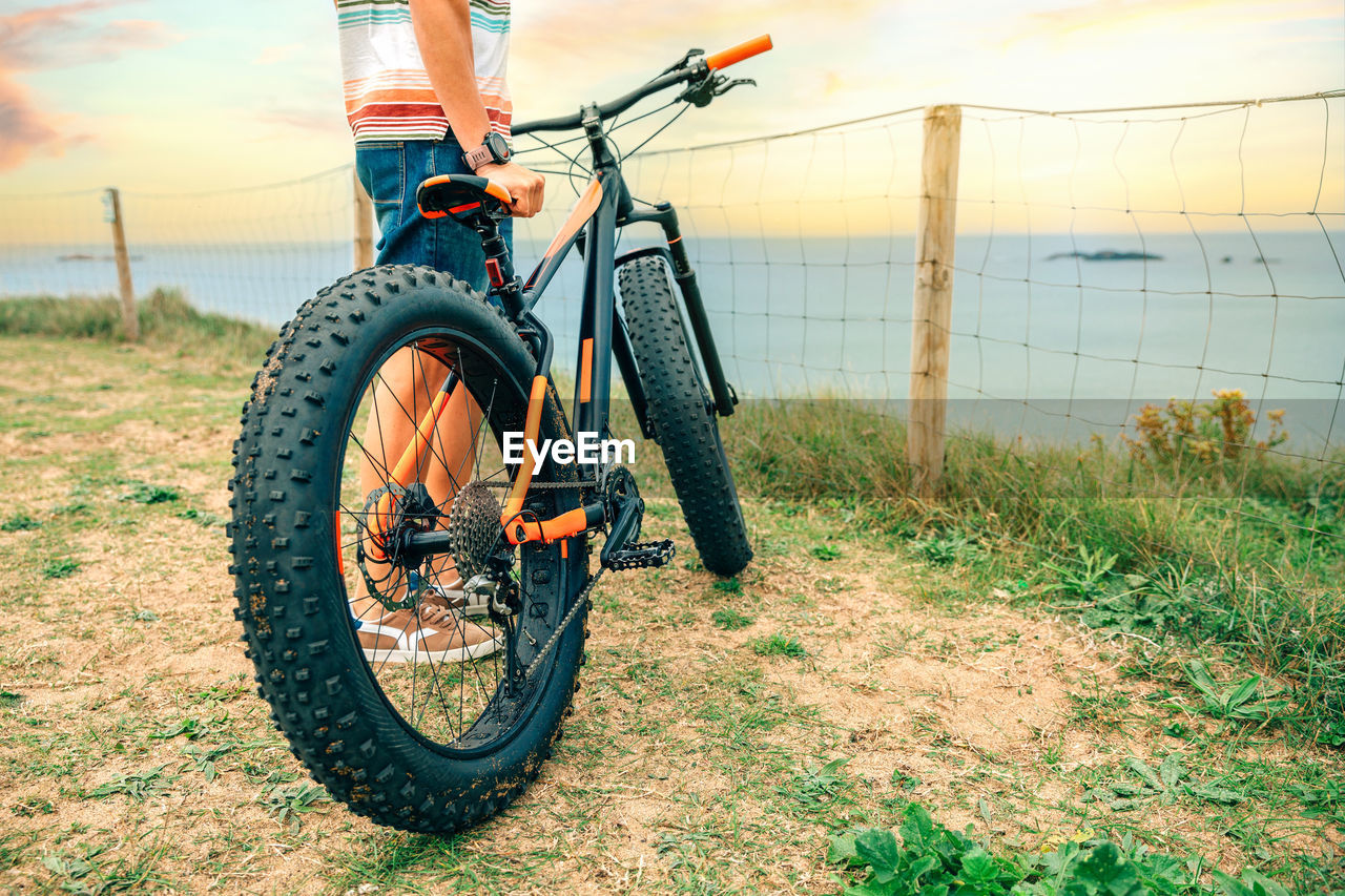 Fat bike on the beach with guy holding it