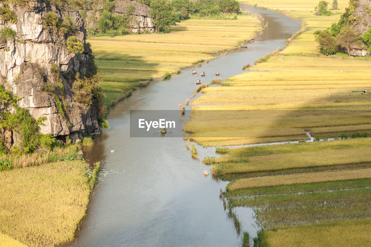 HIGH ANGLE VIEW OF RIVER ALONG ROAD