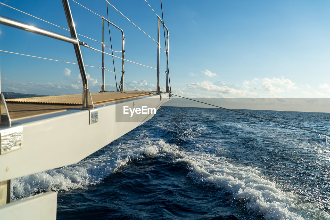 Scenic view of sea against sky with boat gangway in foreground