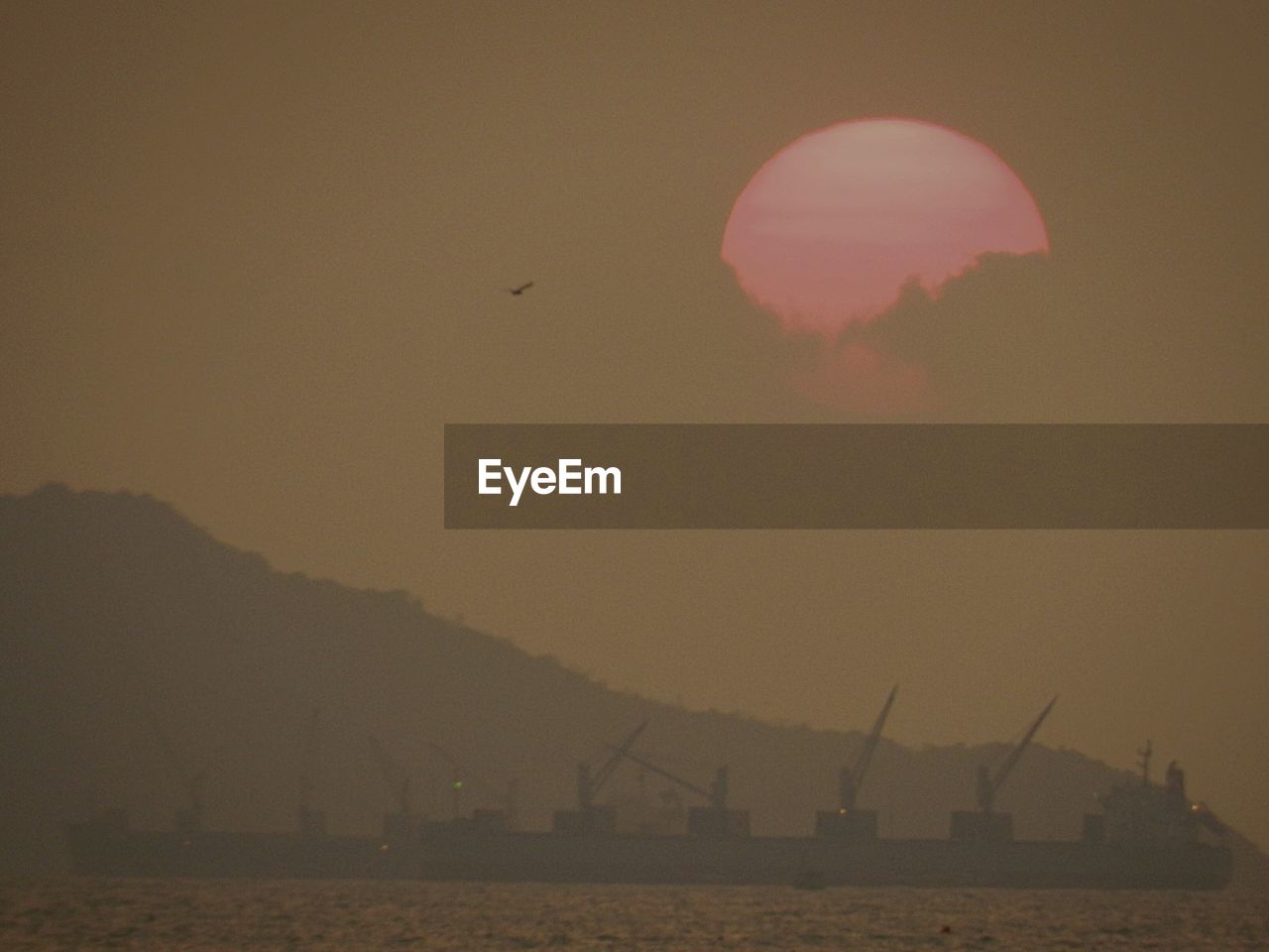 SILHOUETTE OF MOON AT SUNSET