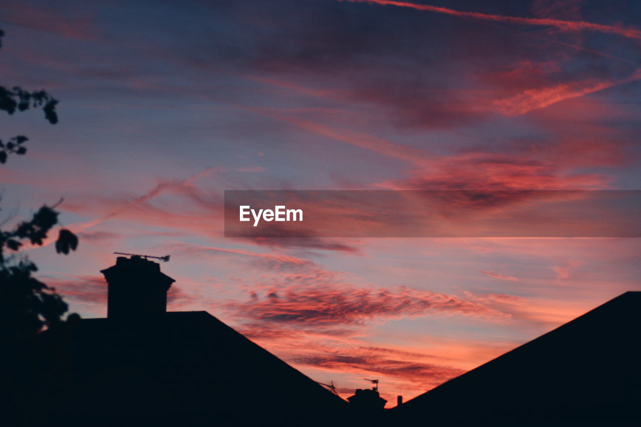 Silhouette buildings against sky during sunset