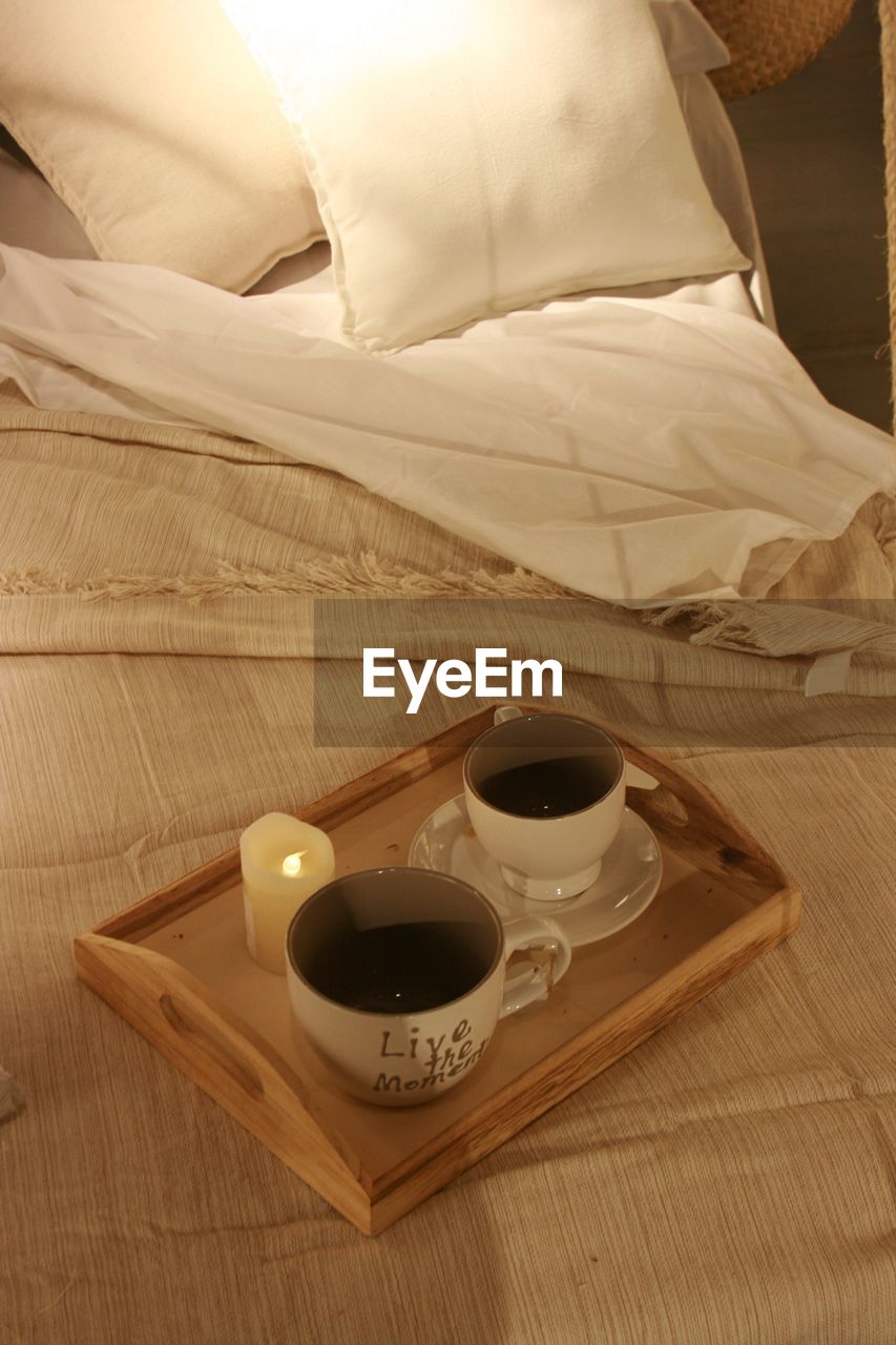 High angle view of coffee in tray on bed