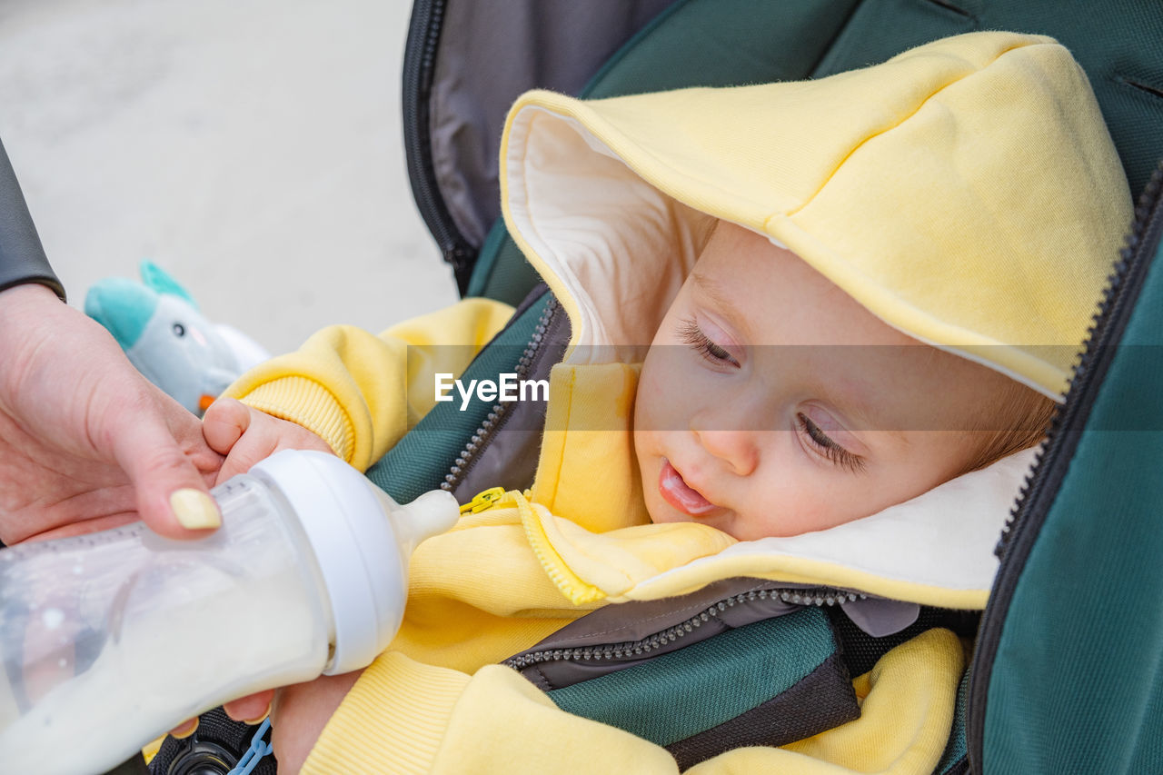 high angle view of cute baby girl in warm clothes