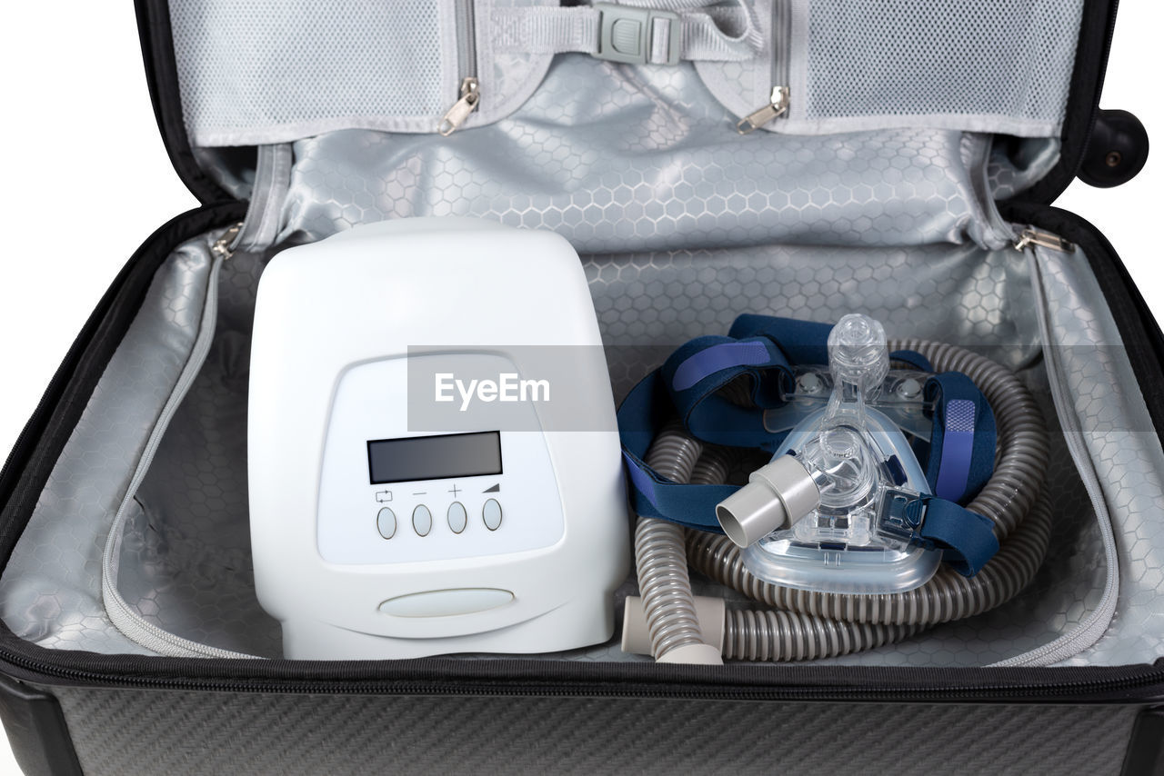 Close-up of medical equipment in suitcase against white background