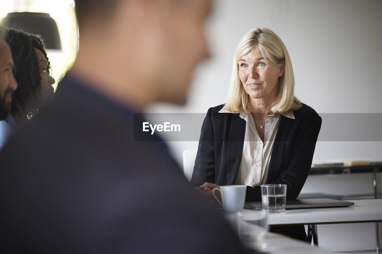 Smiling businesswoman at meeting