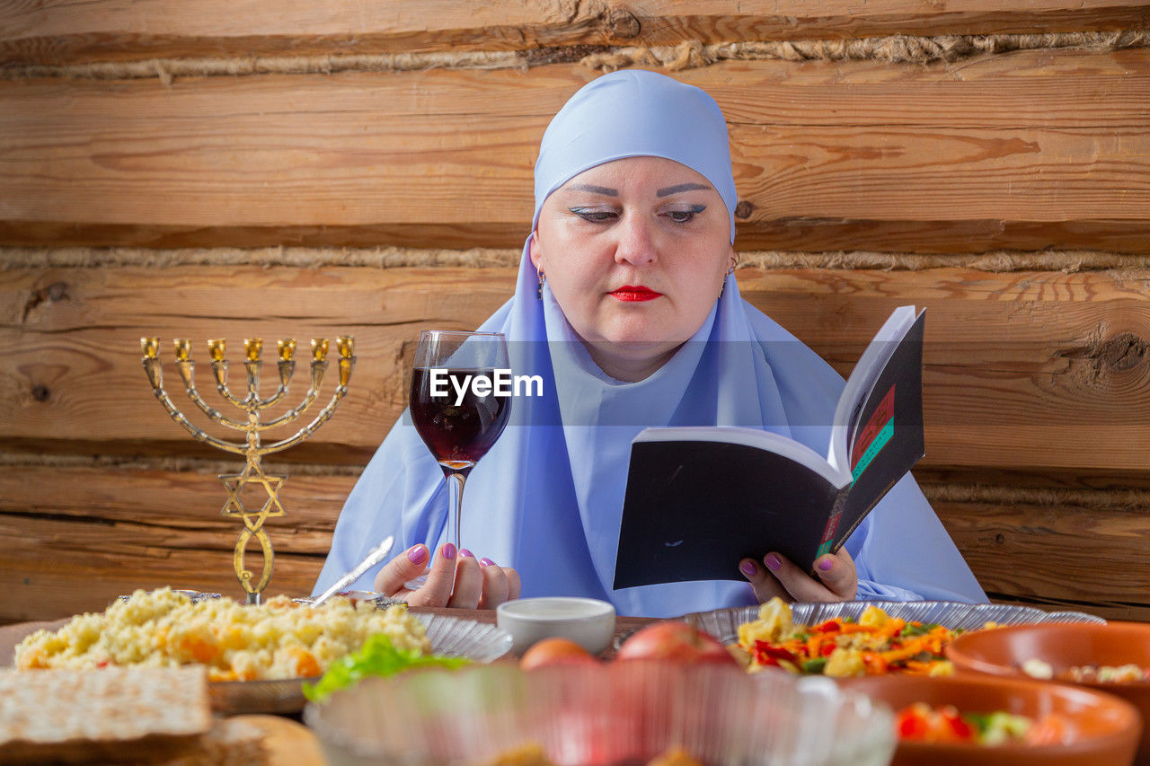 portrait of young woman having food at table