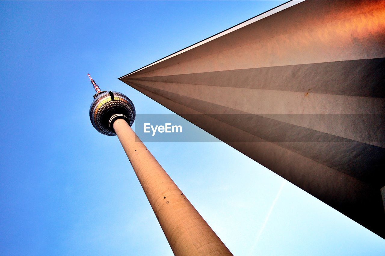 Low angle view of fernsehturm amidst clear blue sky