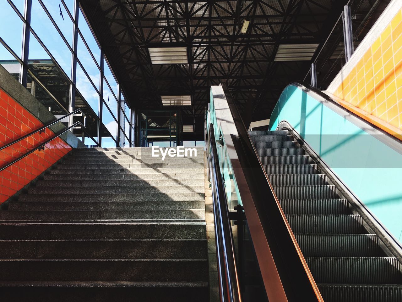Low angle view of empty steps and escalator at railroad station