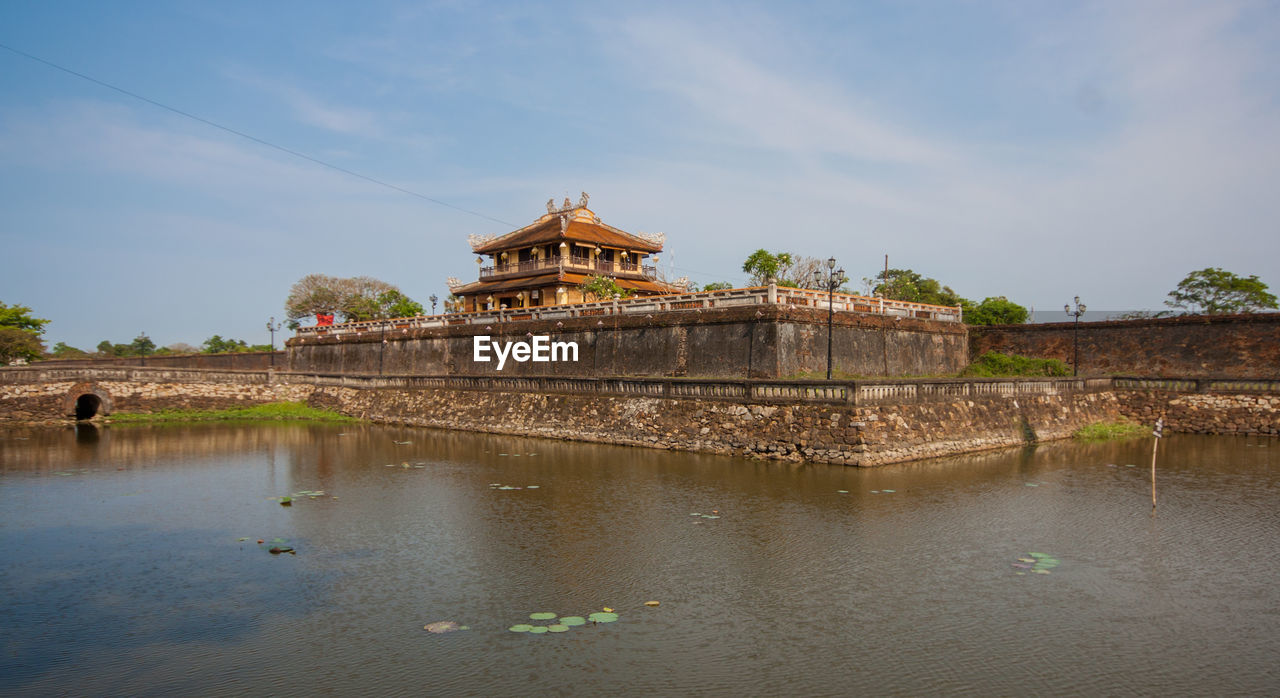 VIEW OF BUILDING BY LAKE