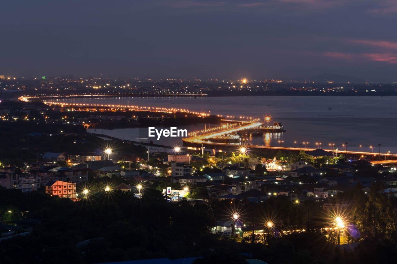 High angle view of illuminated cityscape against sky at night