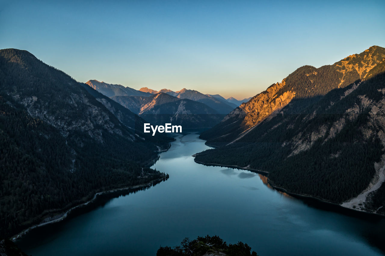 Scenic view of lake and mountains against sky