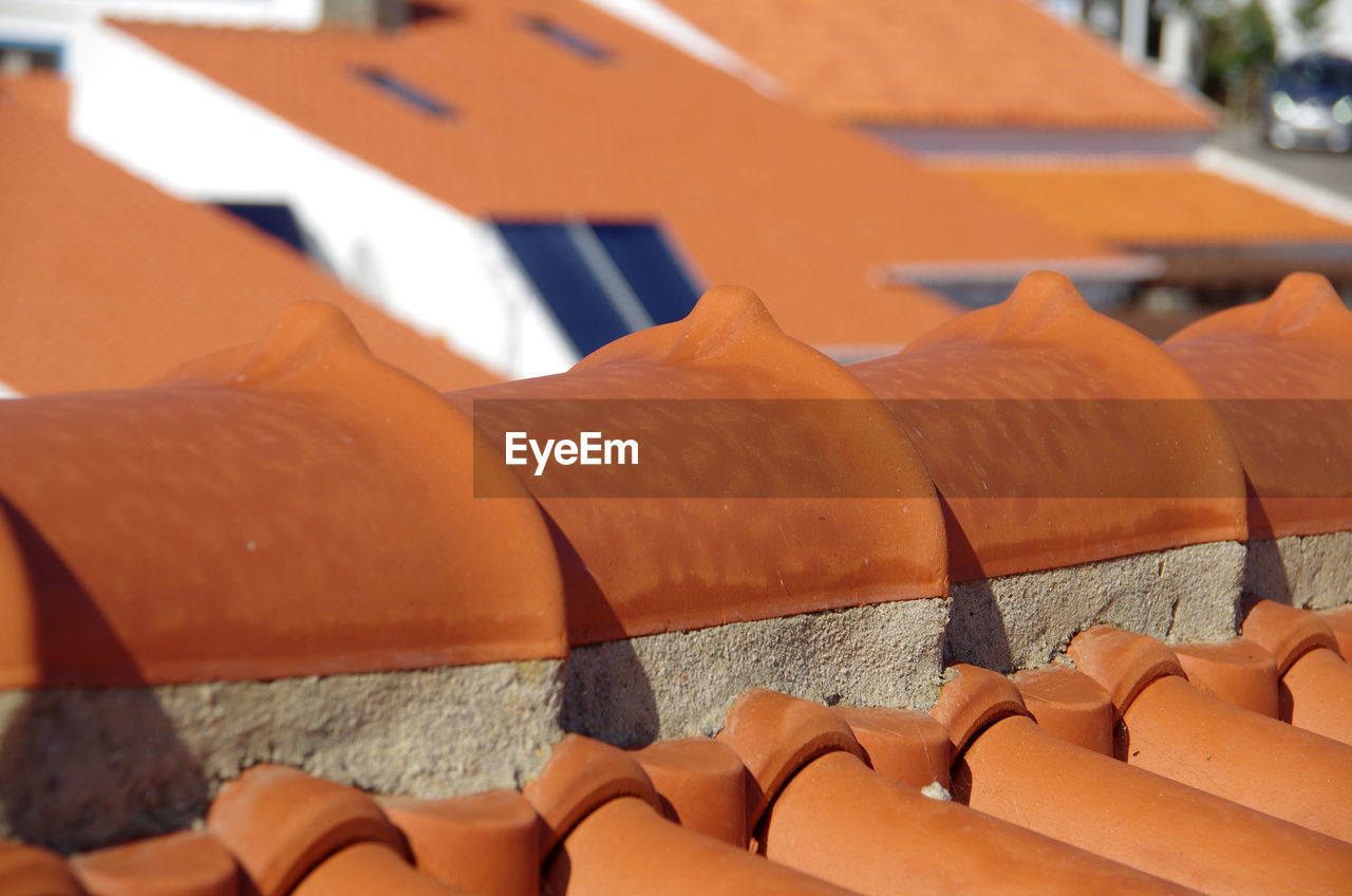 A close up detailed view of part of a red tile roof