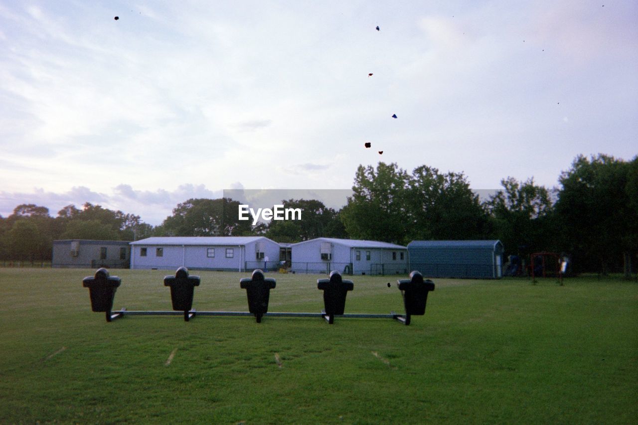 REAR VIEW OF PEOPLE ON SOCCER FIELD