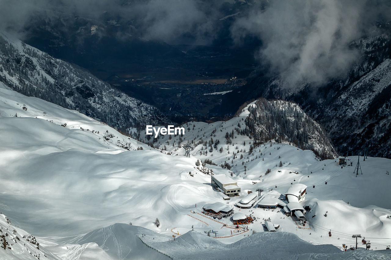 Beautiful environment and view from above to ski resort. scenic view of snow covered mountains.