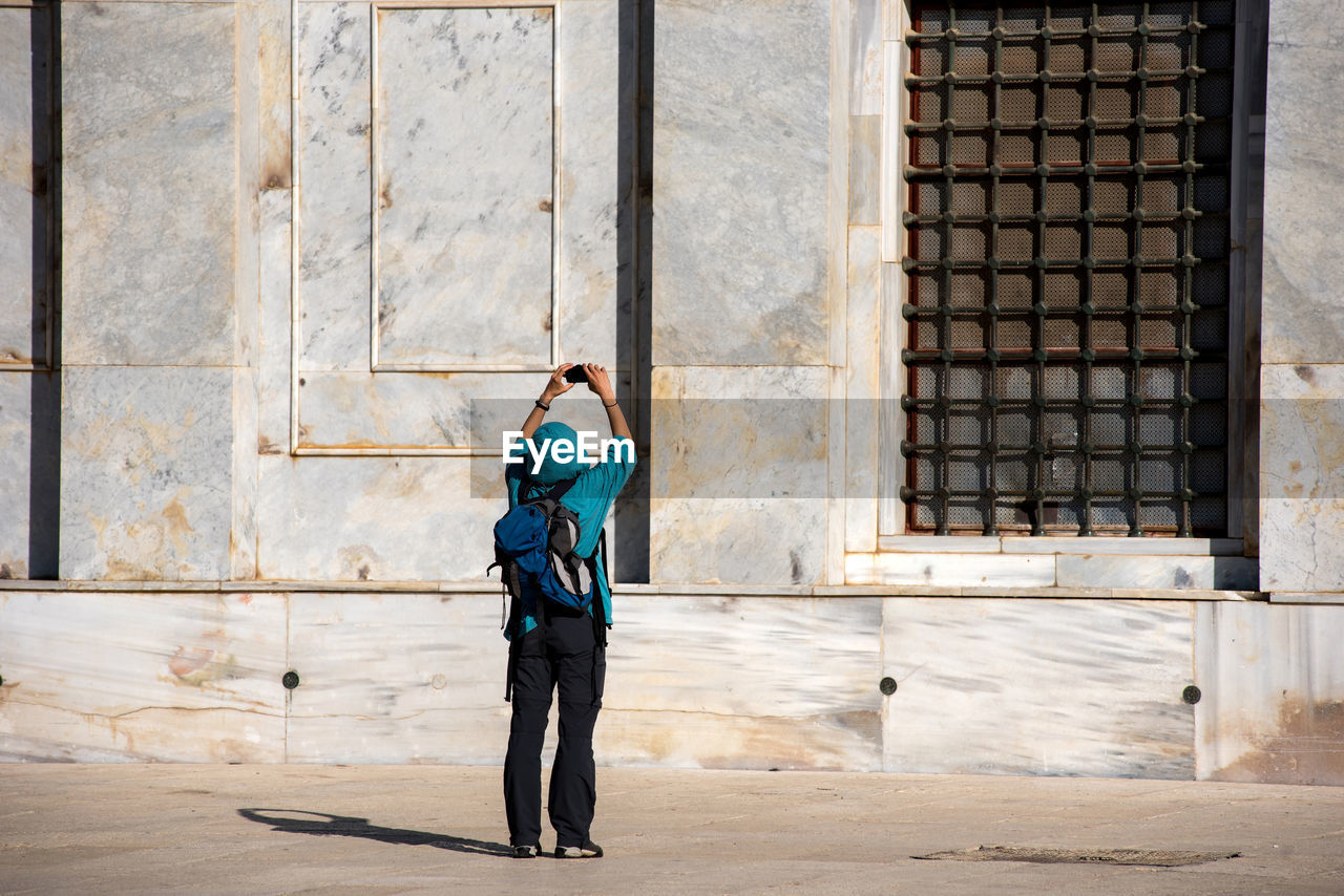 Woman photographing dome of the rock on the temple mount. jerusalem, israel