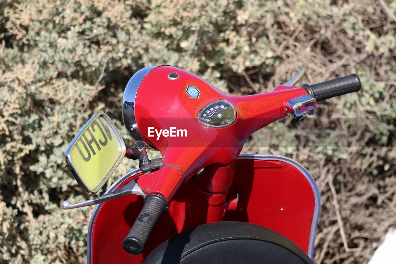 High angle view of red motor scooter against plant