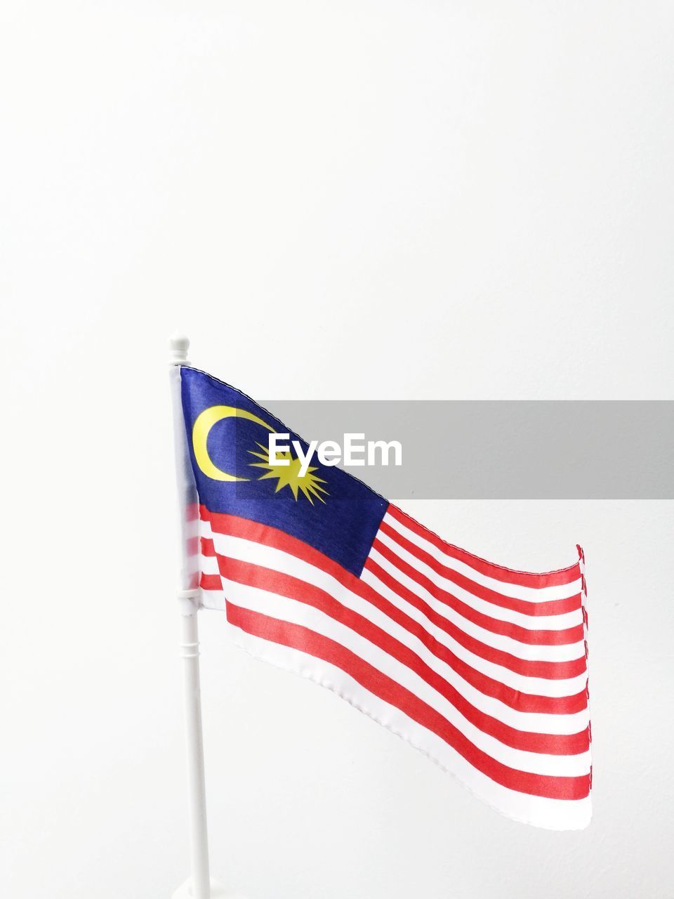 LOW ANGLE VIEW OF FLAG OVER WHITE BACKGROUND