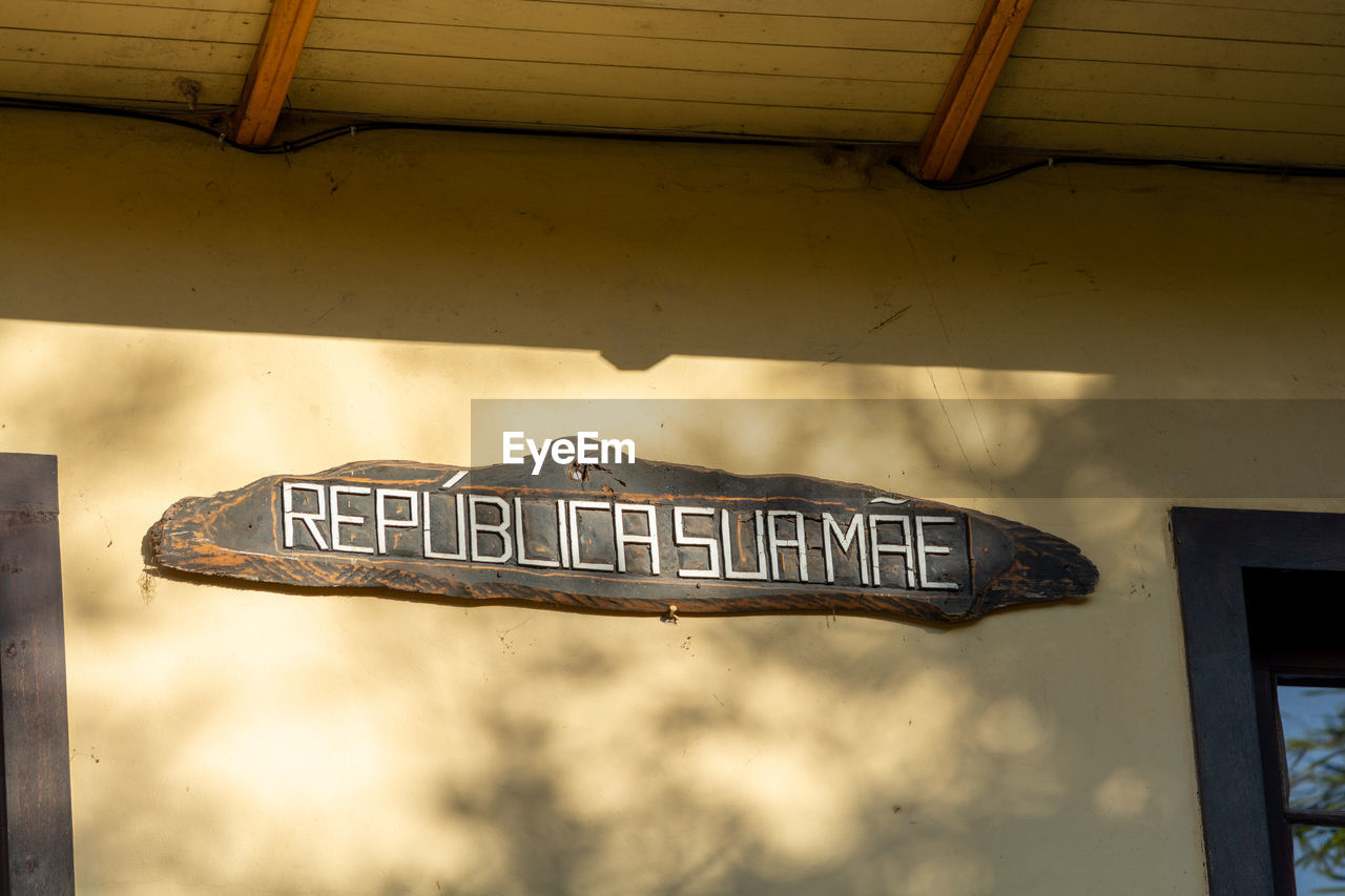 LOW ANGLE VIEW OF SIGN BOARD AGAINST THE SKY