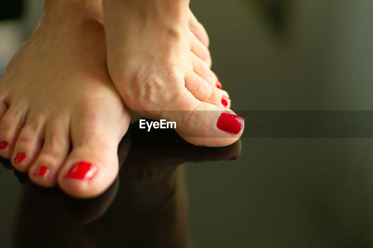 toe, nail polish, human foot, nail, adult, close-up, human leg, red, women, hand, toenail, one person, human mouth, barefoot, finger, red nail polish, fingernail, limb, pedicure, low section, indoors, relaxation, human limb, arm, fashion, lifestyles, person