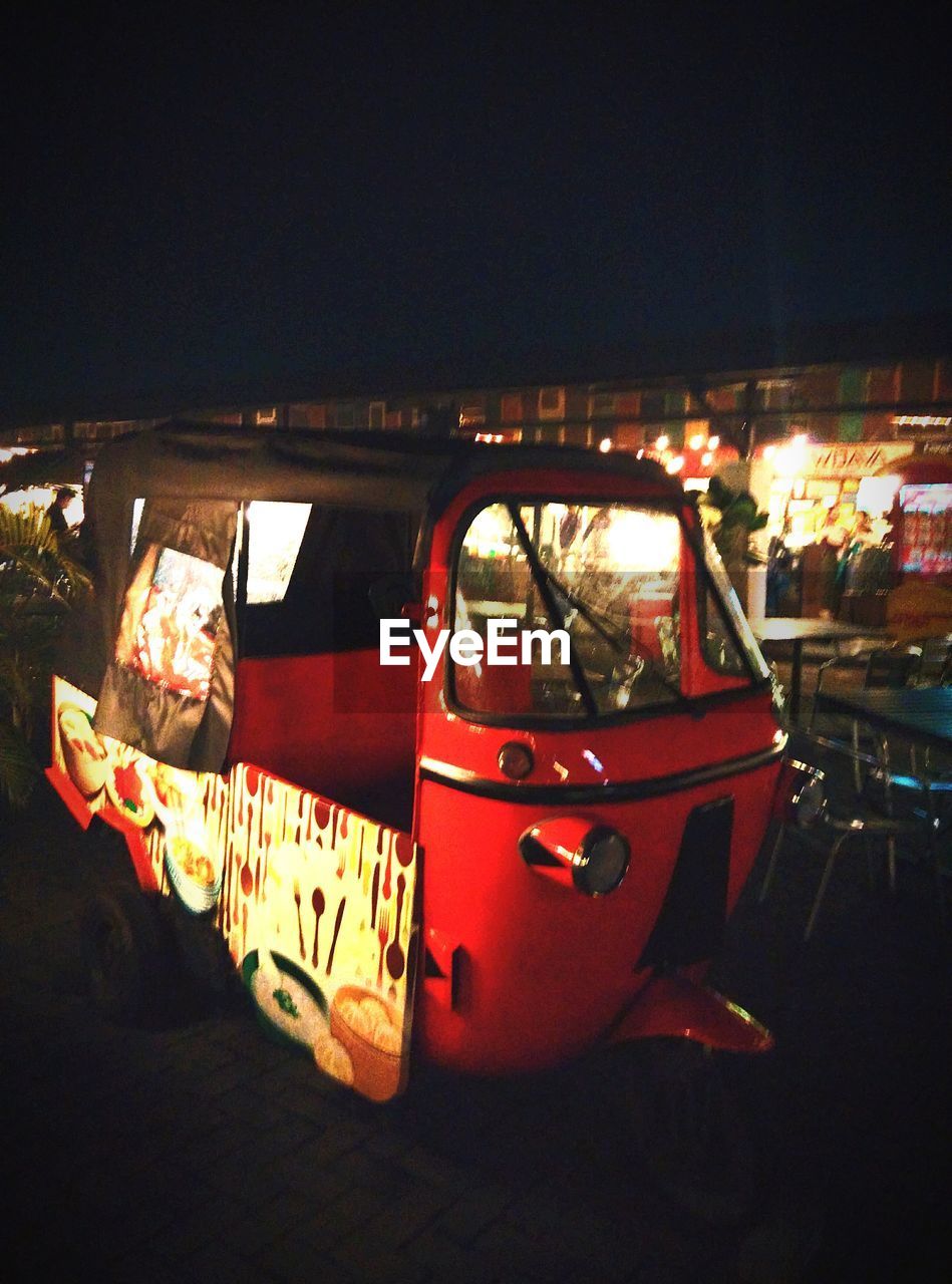 VINTAGE CAR ON STREET AT NIGHT