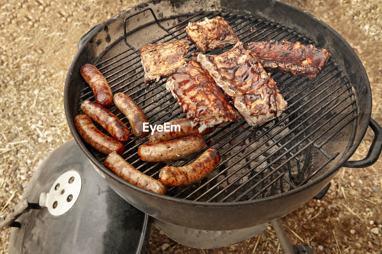 HIGH ANGLE VIEW OF MEAT COOKING ON BARBECUE