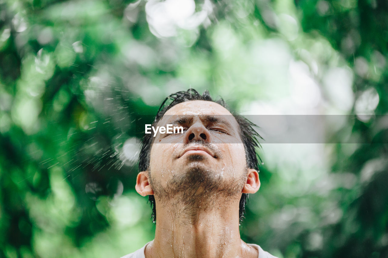 Man with eyes closed at park