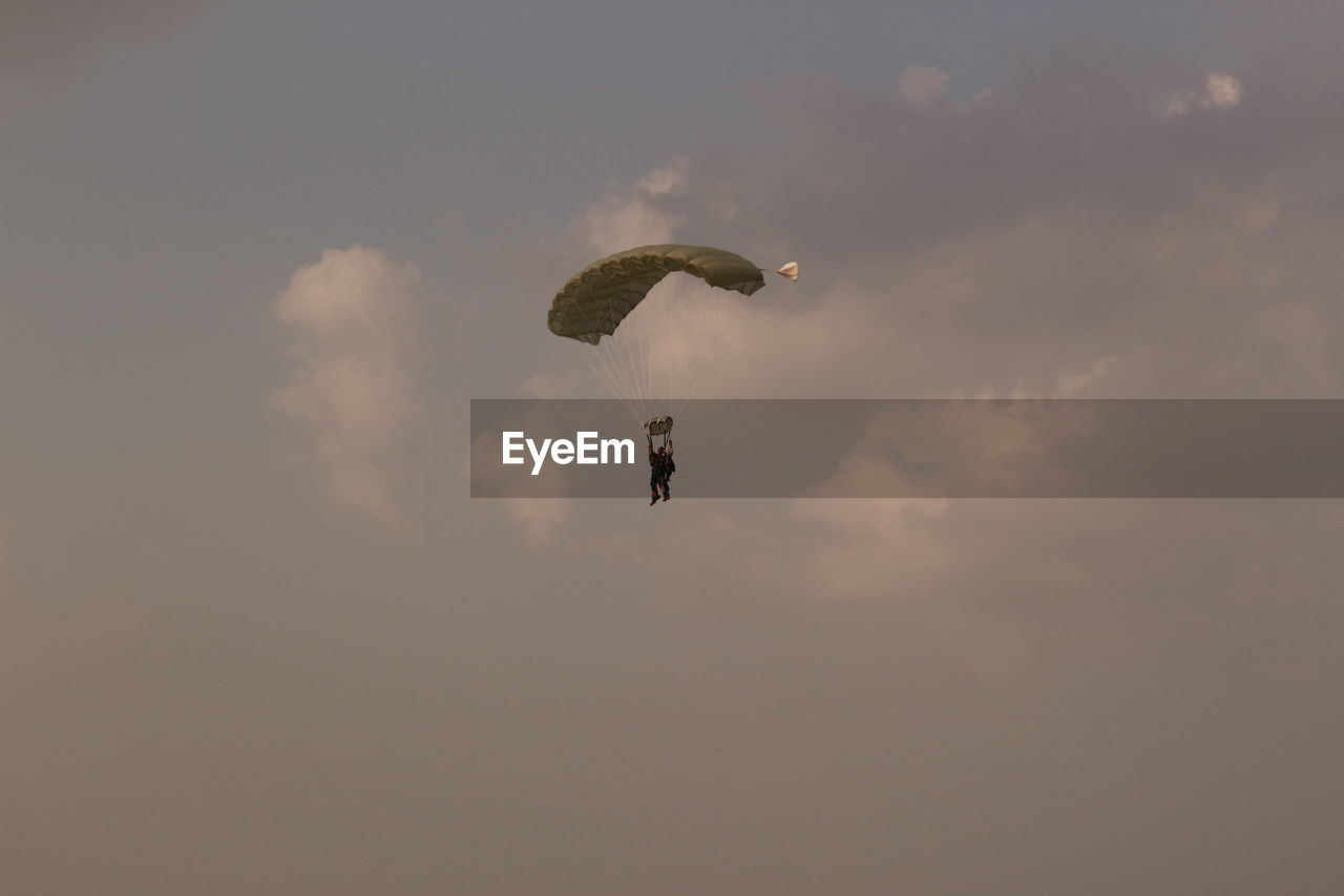 LOW ANGLE VIEW OF PERSON PARAGLIDING