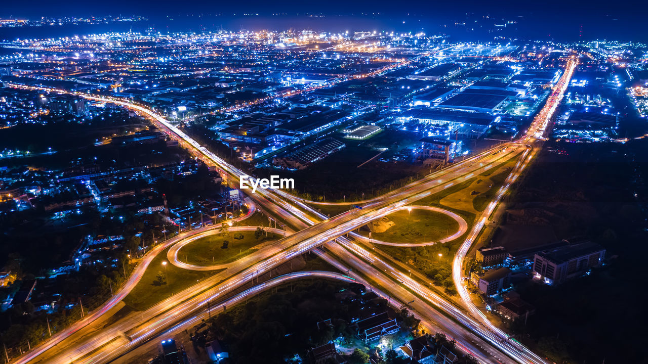 Aerial view interchange ring road and motorway freeway highways and moving headlight cars 