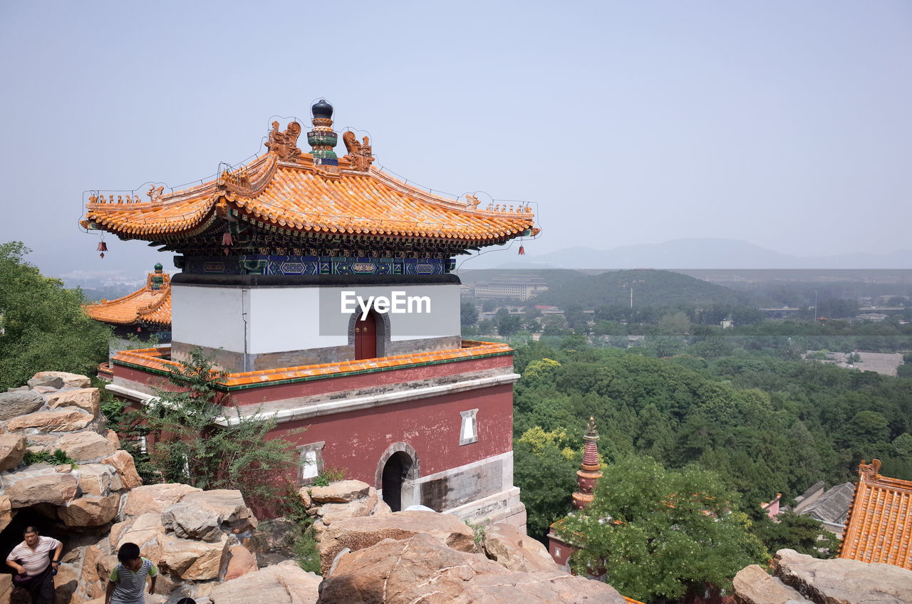 High angle view of man and boy walking by temple