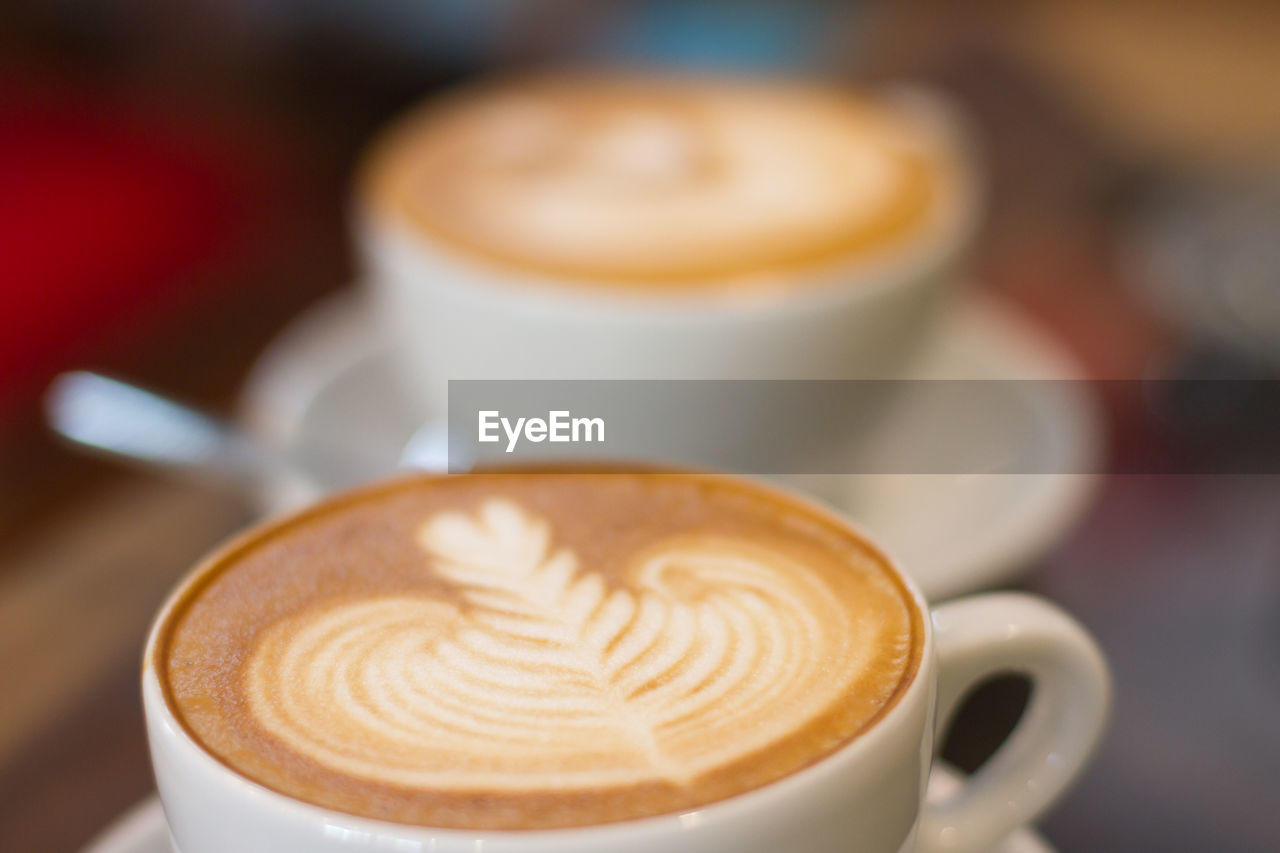Close-up of two white coffee cups