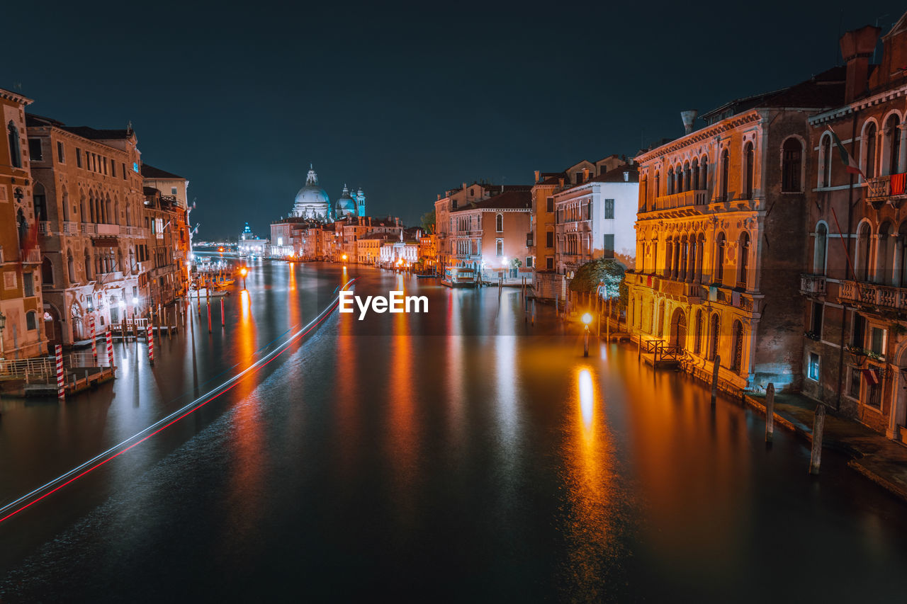 Grand canal amidst illuminated buildings in city at night